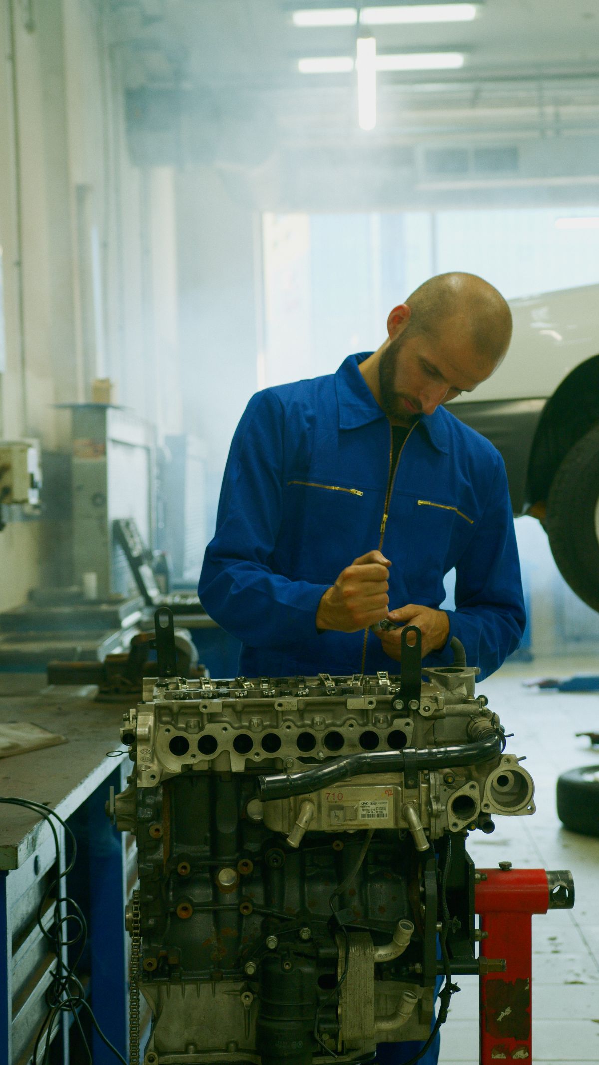Mechanic repairing an engine in a professional workshop